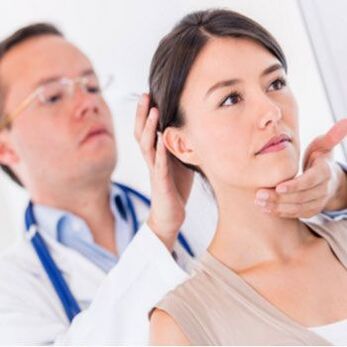 Neurologist examines patient with neck pain